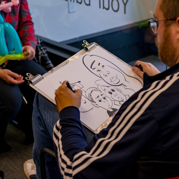 Caricature artist drawing a family