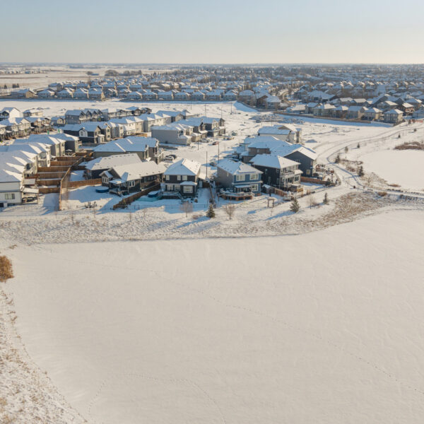 Aerial view of ponds and homes covered in snow in Dansereau Meadows, Beaumont, Alberta.
