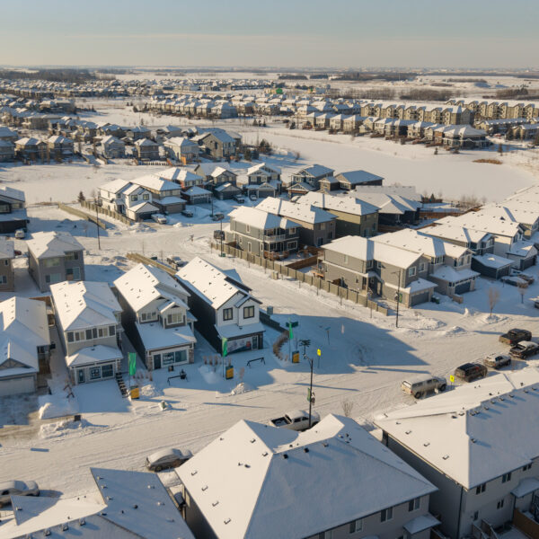 Aerial view of snow covered ponds and homes in Dansereau Meadows, Beaumont, Alberta.