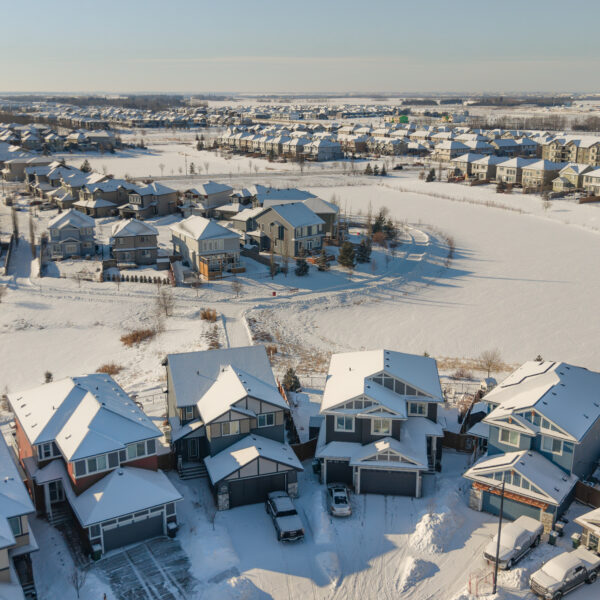 Aerial image of homes and streets in winter in Dansereau Meadows, Beaumont, Alberta.