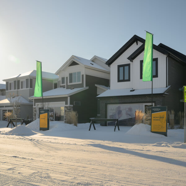 Showhomes along a snow covered street in Dansereau Meadows, Beaumont, Alberta.