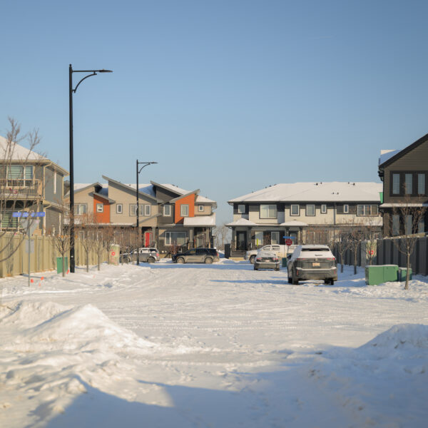 Residential street with light snow in Dansereau Meadows, Beaumont, Alberta.